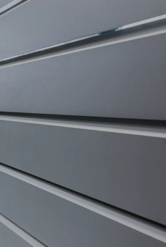 Close-up of the louvred slats of a powder-coated aluminium gate