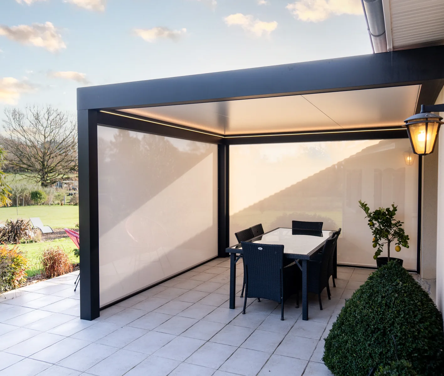 Lily Kostum lean-to aluminium pergola fitted with white zip blinds